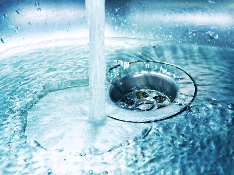 A,Stream,Of,Clean,Water,Flows,Into,The,Stainless,Steel