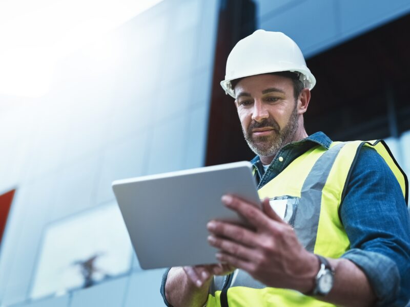 Tablet,,Engineer,And,Man,With,Helmet,On,Construction,Site,For